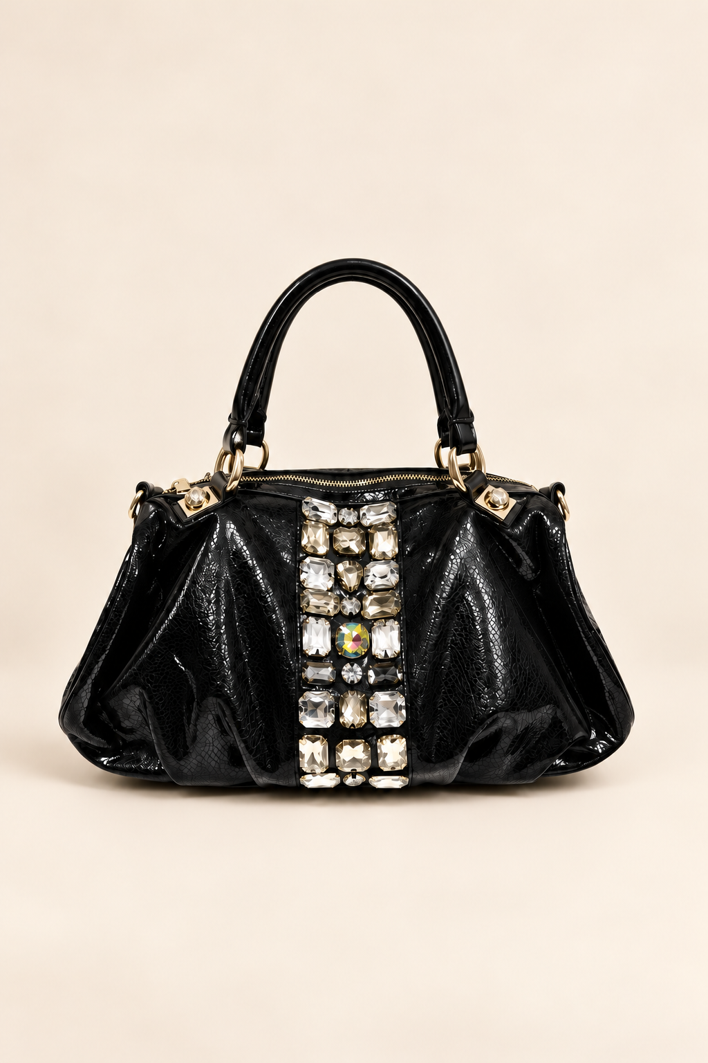 The Headliner Bag in glossy black with a center panel of oversized crystals and gold hardware, front view